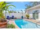 Relaxing pool area with dolphin water feature, lounge chairs, and lush landscaping at 320 Avenida Leona, Sarasota, FL 34242