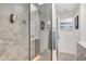 A modern shower with a glass enclosure and gray stone-look tile with a niche at 320 Avenida Leona, Sarasota, FL 34242