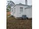 Side view of the house showcasing the exterior and AC unit at 3218 Avenue A W, Bradenton, FL 34205