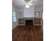 Living room with hardwood floors, fireplace, built-in shelves, and ceiling fan at 3218 Avenue A W, Bradenton, FL 34205