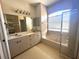 Bathroom with dual sink vanity, garden tub, and tiled shower enclosure at 3409 Branch Creek Dr, Sarasota, FL 34235