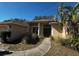 View of the home's front entrance with columns, a stucco facade, and tropical landscaping at 3409 Branch Creek Dr, Sarasota, FL 34235