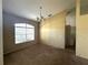 View of the living room featuring an arched window and an overhead chandelier at 3409 Branch Creek Dr, Sarasota, FL 34235