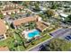 Aerial view of a condo community featuring a swimming pool and ample parking at 3471 Clark Rd # 269, Sarasota, FL 34231