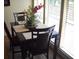 Bright dining room with a table for four, set near a large window at 3471 Clark Rd # 269, Sarasota, FL 34231