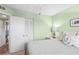 Guest bedroom with a queen bed, ceiling fan, and light-colored walls at 3620 Ironwood Cir # 405, Bradenton, FL 34209