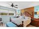 King-size bed, ensuite bathroom access, and coastal decor at 3620 Ironwood Cir # 405, Bradenton, FL 34209