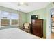 Bedroom with king-size bed, dresser, and relaxing armchair at 3620 Ironwood Cir # 405, Bradenton, FL 34209