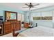 Main bedroom with dresser, ceiling fan, and access to balcony at 3620 Ironwood Cir # 405, Bradenton, FL 34209