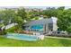 Enclosed community pool with surrounding deck and shuffleboard at 3620 Ironwood Cir # 405, Bradenton, FL 34209