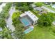 Enclosed community pool with surrounding deck and shuffleboard at 3620 Ironwood Cir # 405, Bradenton, FL 34209