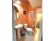 Small bathroom with pedestal sink, toilet and access to laundry at 3825 45Th W Ter # 104, Bradenton, FL 34210