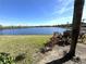 Scenic view of a lake with lush green grass and tropical plants in the foreground at 3825 45Th W Ter # 104, Bradenton, FL 34210