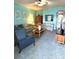 Spacious living room with teal walls, carpeting, and ample seating at 3825 45Th W Ter # 104, Bradenton, FL 34210