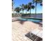 Community pool with lounge chair and waterfront view at 3825 45Th W Ter # 104, Bradenton, FL 34210