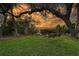 Relaxing backyard with a swing under a large oak tree at 3950 Red Rock Way, Sarasota, FL 34231