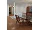 Dining room area featuring a glass dining table, bamboo chairs and hardwood floors at 4108 Carriage Way # 6, Sarasota, FL 34241