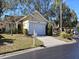 Tan house with white garage door and landscaping at 4108 Carriage Way # 6, Sarasota, FL 34241