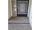 Close-up of the front entryway features a decorative security door and pebble-stone concrete at 4108 Carriage Way # 6, Sarasota, FL 34241