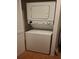 Compact, stacked washer and dryer unit maximizes space, perfect for smaller homes or apartments at 4108 Carriage Way # 6, Sarasota, FL 34241