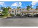 Two-story condo building with covered parking and lush landscaping at 4250 Players Pl # 2622, Sarasota, FL 34238