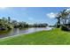 Spacious backyard with water view and lush landscaping at 4503 Coral Lake Dr, Bradenton, FL 34210