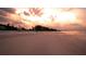 Sunset over a beach with people and clouds at 4503 Coral Lake Dr, Bradenton, FL 34210