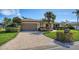 Brick driveway leading to a house with landscaping at 4503 Coral Lake Dr, Bradenton, FL 34210