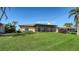 House exterior with screened patio and manicured lawn at 4503 Coral Lake Dr, Bradenton, FL 34210
