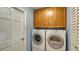 Bright laundry room with washer, dryer, and cabinets at 4503 Coral Lake Dr, Bradenton, FL 34210