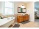 Bathroom with soaking tub, double vanity, and a walk-in shower at 4517 N Lake Dr, Sarasota, FL 34232