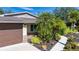 House exterior with brown garage door and landscaping at 4517 N Lake Dr, Sarasota, FL 34232