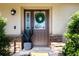 Inviting front door with wreath, stone accents, and potted plants at 4517 N Lake Dr, Sarasota, FL 34232