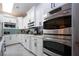 Modern white kitchen with stainless steel appliances and quartz countertops at 4517 N Lake Dr, Sarasota, FL 34232