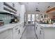 Modern kitchen with white cabinets, a large island, and tile flooring at 4517 N Lake Dr, Sarasota, FL 34232