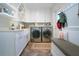 Well-equipped laundry room with ample storage and a built-in bench at 4517 N Lake Dr, Sarasota, FL 34232