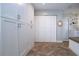 Bright laundry room with ample storage and herringbone tile floor at 4517 N Lake Dr, Sarasota, FL 34232