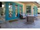 Relaxing patio with wicker furniture and teal doors leading inside at 4517 N Lake Dr, Sarasota, FL 34232