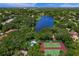 Aerial view of community, featuring lake, pool, and tennis courts at 4563 Trails Dr, Sarasota, FL 34232