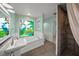 Bathroom featuring a stained-glass window, soaking tub, and shower at 4563 Trails Dr, Sarasota, FL 34232