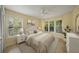 Bright bedroom featuring hardwood floors and multiple windows at 4563 Trails Dr, Sarasota, FL 34232