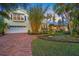 Beautiful two-story home with brick driveway and lush landscaping at 4563 Trails Dr, Sarasota, FL 34232