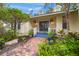 Welcoming front entry with brick walkway and tropical plants at 4563 Trails Dr, Sarasota, FL 34232