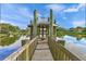 Wooden gazebo on a dock extending over a peaceful lake at 4563 Trails Dr, Sarasota, FL 34232