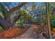 Landscaped backyard with brick patio and tropical plants at 4563 Trails Dr, Sarasota, FL 34232