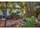 Brick patio area with seating and tropical landscaping at 4563 Trails Dr, Sarasota, FL 34232