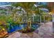 Enclosed pool area with tropical landscaping and stonework at 4563 Trails Dr, Sarasota, FL 34232