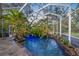 Inviting swimming pool surrounded by tropical plants at 4563 Trails Dr, Sarasota, FL 34232