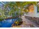 Relaxing pool and patio area with lush tropical landscaping at 4563 Trails Dr, Sarasota, FL 34232