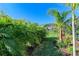 Lush tropical landscaping lines the backyard at 4852 Coastal Days Ln, Bradenton, FL 34211